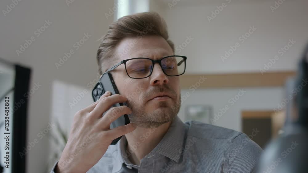 Project manager working with his smartphone at his desk in modern office Project manager working with his smartphone at his desk in modern office