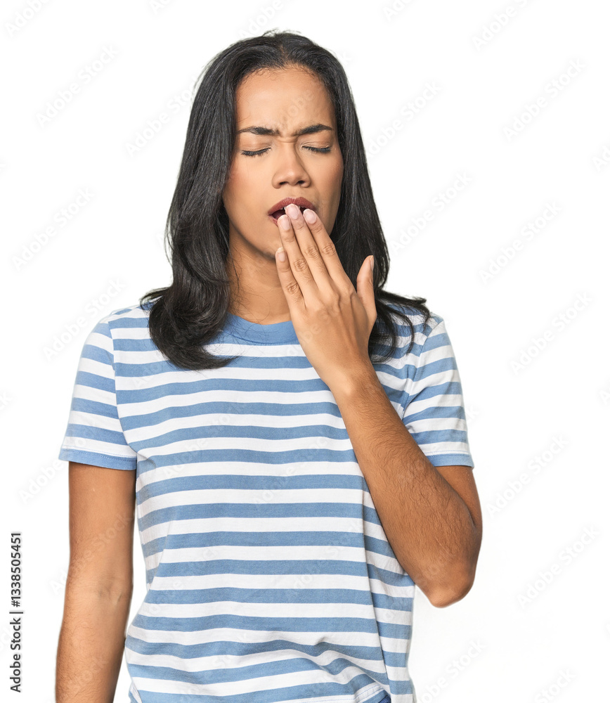 Young Latina posing in studio yawning showing a tired gesture covering mouth with hand. Young Latina posing in studio yawning showing a tired gesture covering mouth with hand.