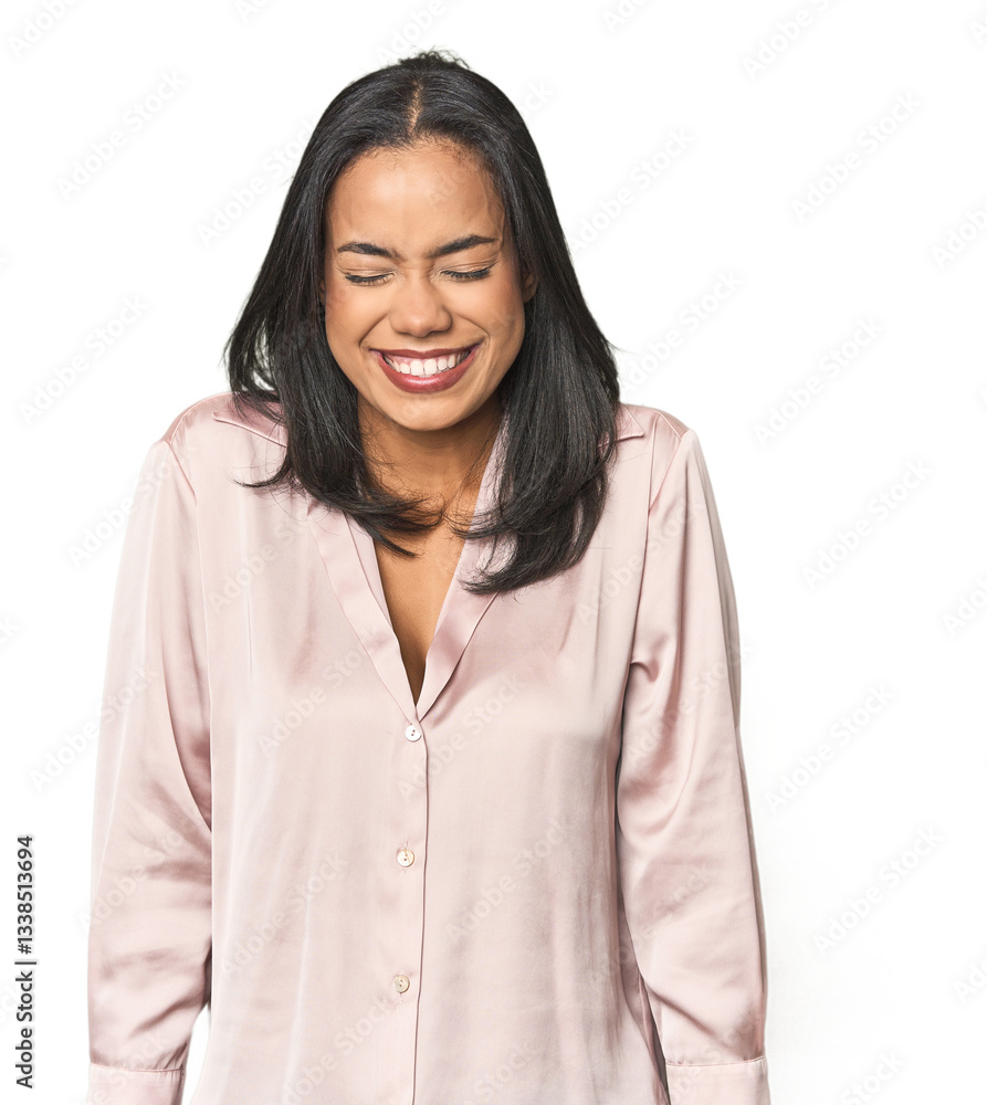 Simple portrait of a young Latina laughs and closes eyes, feels relaxed and happy. Simple portrait of a young Latina laughs and closes eyes, feels relaxed and happy.