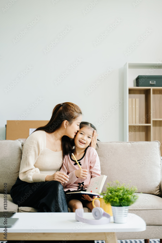 Cheerful mother and daughter sharing quality time on a couch, smiling and using a smartphone together. Cheerful mother and daughter sharing quality time on a couch, smiling and using a smartphone together.