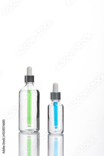 transparent dropper bottle with white bottom and colored dropper