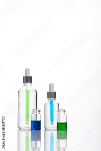 transparent dropper bottle with white bottom and colored dropper