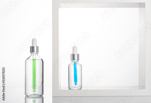 transparent dropper bottle with white bottom and colored dropper