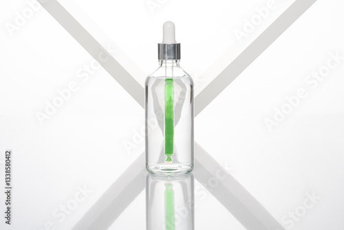 transparent dropper bottle with white bottom and colored dropper