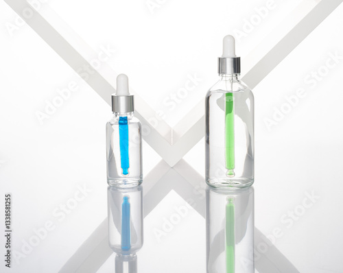 transparent dropper bottle with white bottom and colored dropper