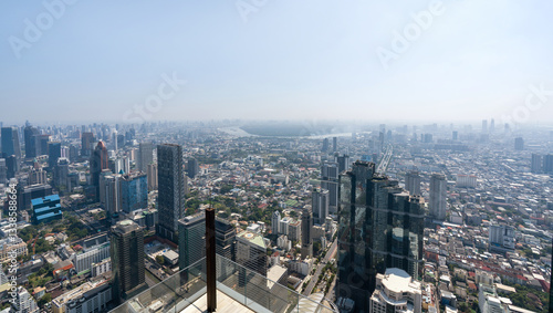 A panoramic view of a bustling city featuring skyscraper and a mix of urban building. The clear sky provide a stunning backdrop to the dynamic landscape below. Bangkok, Thailand.