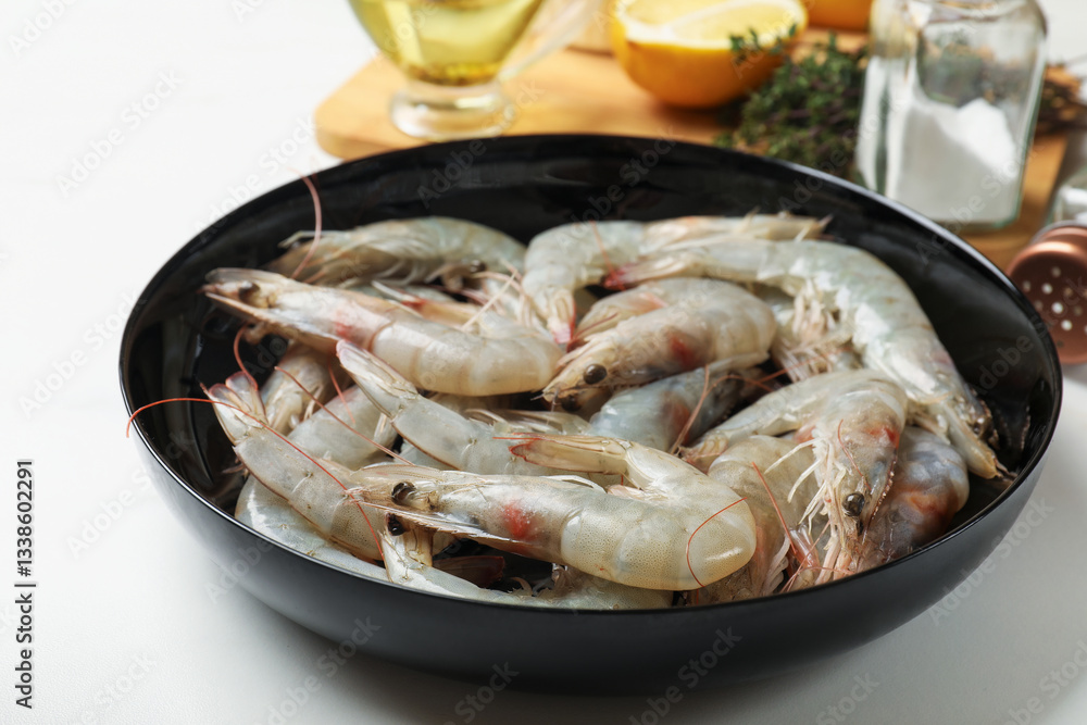 Fresh raw shrimps and spices on white table, closeup Fresh raw shrimps and spices on white table, closeup
