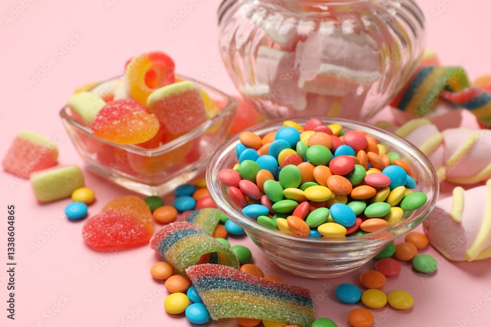 Many different tasty candies on pink background, closeup Many different tasty candies on pink background, closeup