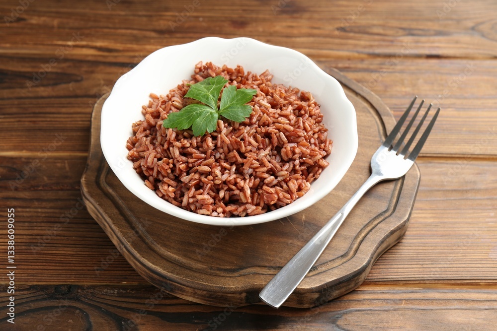 Delicious brown rice with parsley served on wooden table Delicious brown rice with parsley served on wooden table