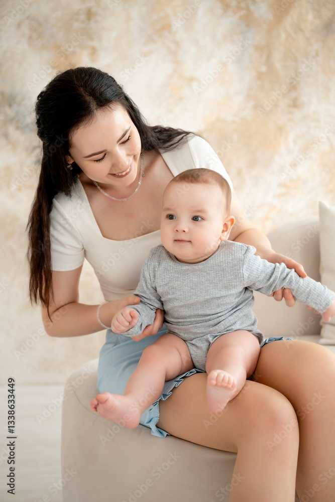 mom and baby, mother hugs and kisses baby holding him in her arms, maternal love and care, young mom having fun with baby baby, mom's decree mom and baby, mother hugs and kisses baby holding him in her arms, maternal love and care, young mom having fun with baby baby, mom's decree