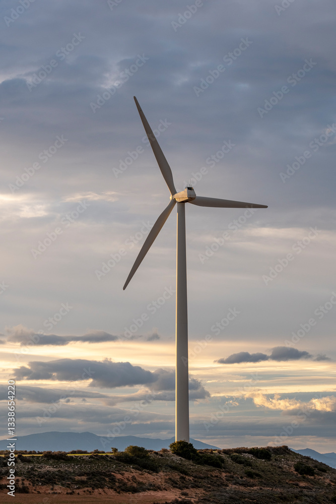 Wind turbine against a textured sky at dusk, showcasing the contrast between nature and sustainable technology in Zaragoza’s evolving energy landscape. Wind turbine against a textured sky at dusk, showcasing the contrast between nature and sustainable technology in Zaragoza’s evolving energy landscape.