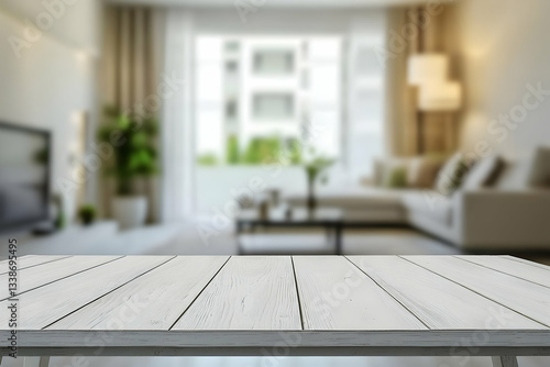 A white wooden table placed in front of a blurred living room in a modern apartment creates a clean and simple design.