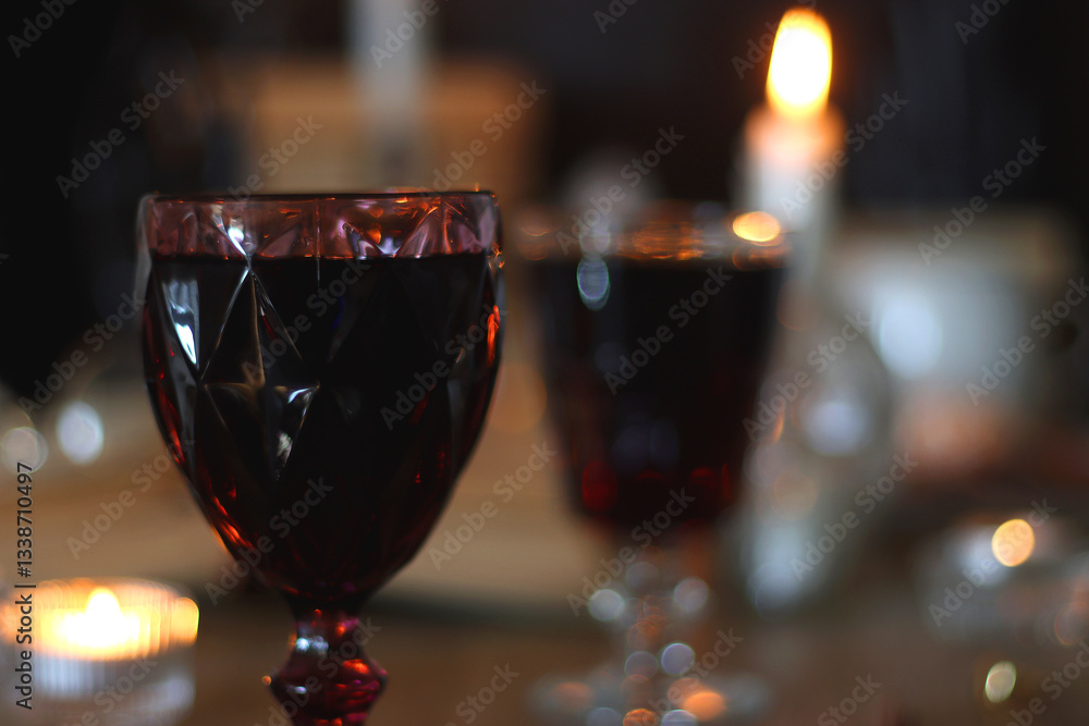 Books, lit candles, red wine, snacks and various deocration on the table. Dark academia or Halloween concept. Selective focus.
