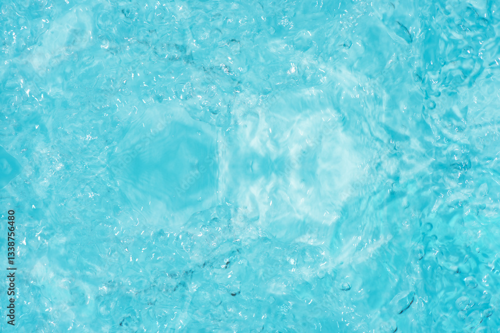 Obraz premium Blue water with ripples on the surface. Defocus blurred transparent blue colored clear calm water surface texture with splashes and bubbles. Water waves with shining pattern texture background.