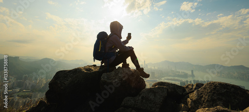 Photography Successful woman hiker sit on the cliff edge taking selfie with smartphone in ho