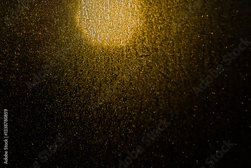 Blurred bokeh light sparkle on golden black background