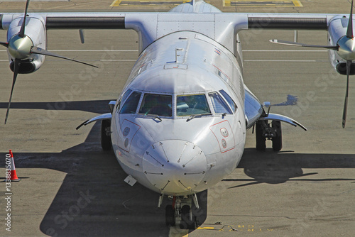 Obraz na płótnie Front View of Turbo Propeller Airplane Dock at Airport w salonie