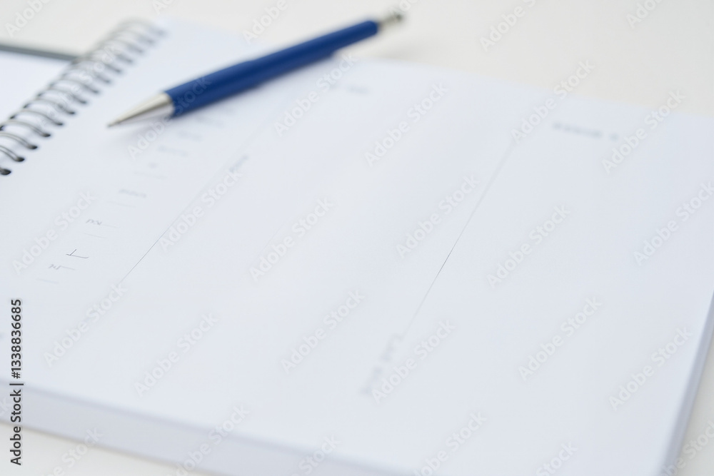 Personal Organizer with Blue Pen and Spiral-Bound Notepad for Productivity and Planning Concepts Personal Organizer with Blue Pen and Spiral-Bound Notepad for Productivity and Planning Concepts