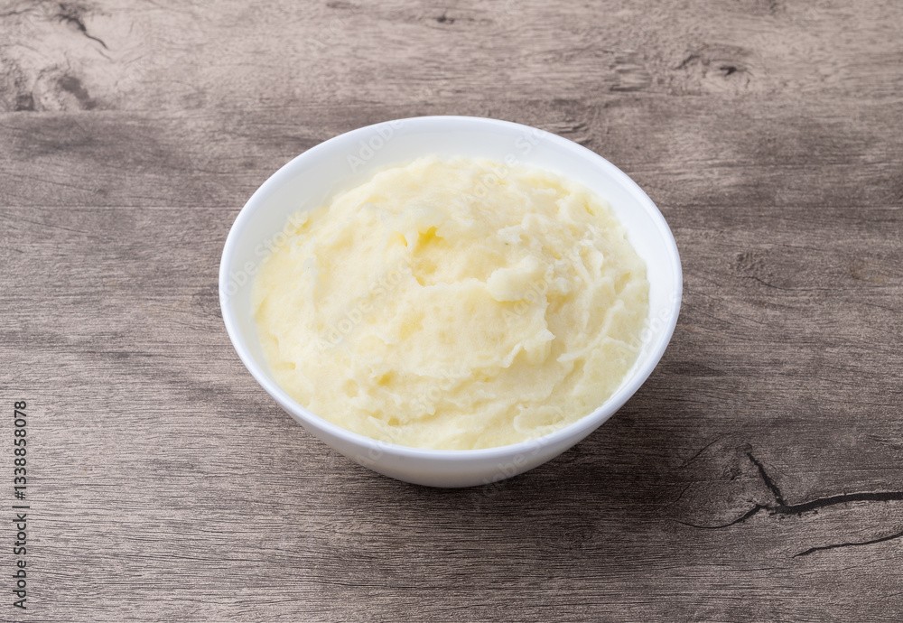 Mashed potatoes in a bowl over wooden table Mashed potatoes in a bowl over wooden table