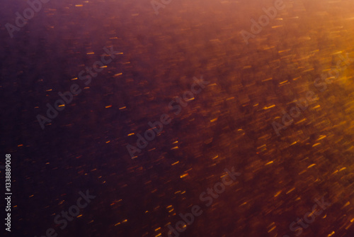 Blurred bokeh light sparkle on golden black background
