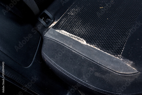Car seat dusted with sand after a beach outing, ideal for automotive care, travel memories, and rugged lifestyle photography.