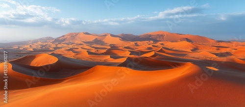 Fototapeta Naklejka Na Ścianę i Meble -  Vast, undulating sand dunes meet the sky in a breathtaking desert landscape.