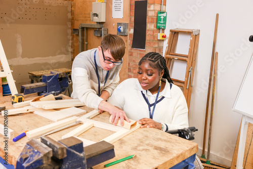 Disabled man and woman working in workshop