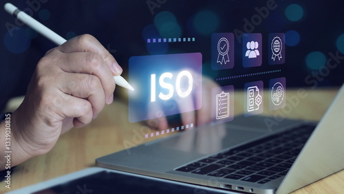 ISO certification and quality management concept. Business professional reviewing ISO certification standards with digital icons representing quality control