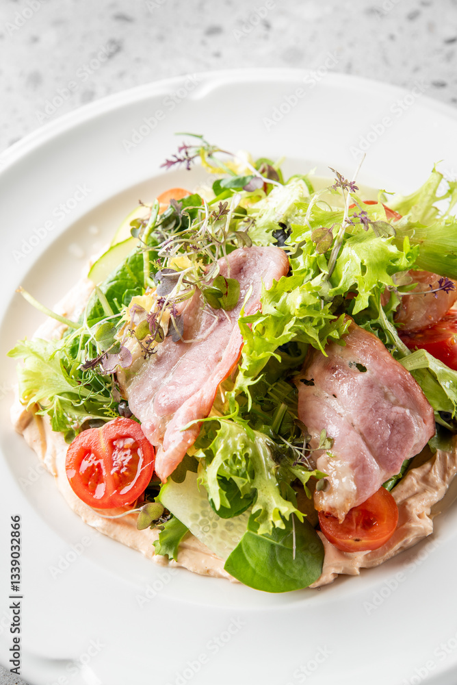 A vibrant salad featuring fresh greens, cherry tomatoes, and slices of meat arranged beautifully on a white plate, garnished with herbs for a colorful presentation. A vibrant salad featuring fresh greens, cherry tomatoes, and slices of meat arranged beautifully on a white plate, garnished with herbs for a colorful presentation.