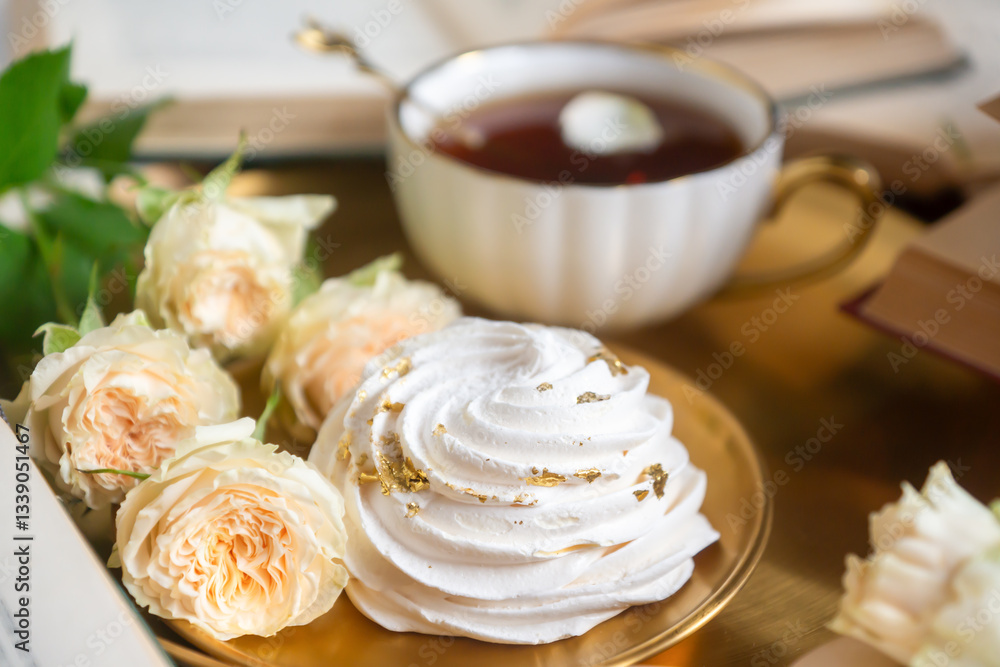 A cup of aromatic tea, a book and a rose on the table. A cup of aromatic tea, a book and a rose on the table.