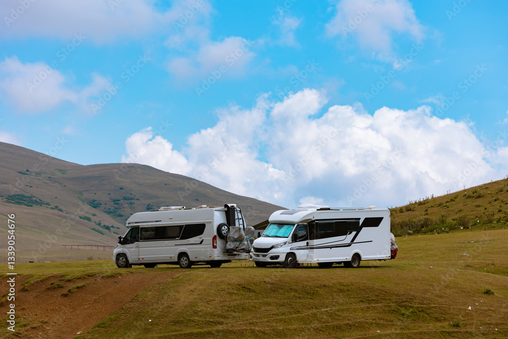 Fototapeta premium Motorhomes on the highland. Adventure concept photo