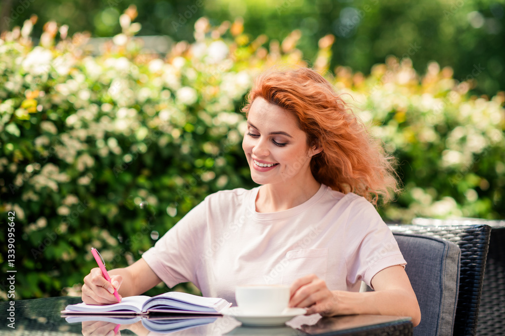 Obraz premium Photo of nice young woman pen book coffee cup cafe table free time fresh air park outdoors