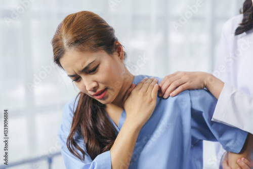 Принти на полотні Doctor comforting her patient suffering from shoulder pain, medical and healthca