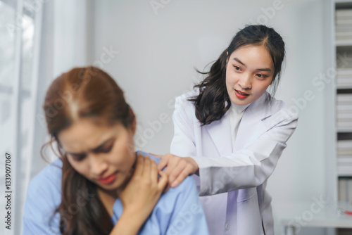 Wallpaper Mural Female medical professional palpating patient's shoulder during painful musculoskeletal assessment Torontodigital.ca