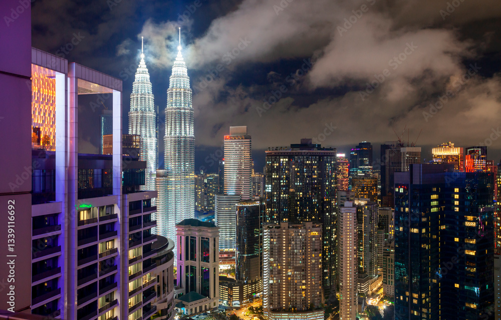 Aerial view of skyscrapers in downtown Kuala Lumpur at night, Malaysia. Skyscrapers of Kuala Lumpur on night sky background in Malaysia. Kuala Lumpur is a popular tourist destination of Asia.