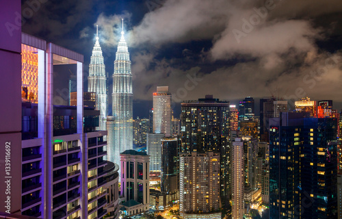 Obraz na płótnie Aerial view of skyscrapers in downtown Kuala Lumpur at night, Malaysia. Skyscrapers of Kuala Lumpur on night sky background in Malaysia. Kuala Lumpur is a popular tourist destination of Asia. w salonie