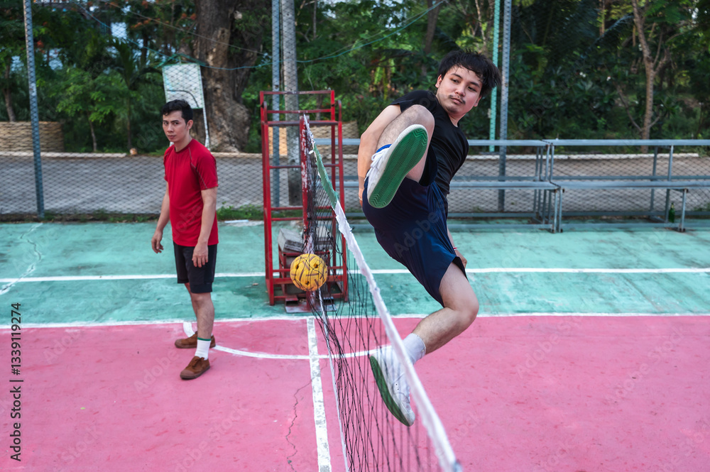 Obraz premium Asian male Sepaktakraw players playing traditional Sepak Takraw sports in outdoor court