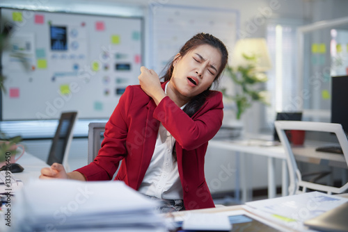 Wall Mural Office worker experiencing discomfort and muscle tension due to prolonged desk w