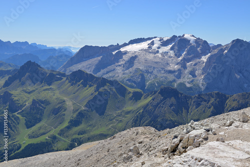 Wonderful sunny mountain panorama under blue sky from the summit of the Sella, Piz Boe. Dolomites (Dolomiti), Italy. In the background the glacier of the mountain Marmolada.