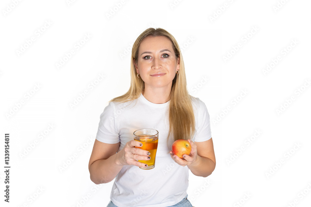 Beautiful fun happy blonde woman holding in hands red apple fresh apple juice glass isolated white background. Proper nutrition, dieting concept. Copy space advertisement. Advertising area Beautiful fun happy blonde woman holding in hands red apple fresh apple juice glass isolated white background. Proper nutrition, dieting concept. Copy space advertisement. Advertising area