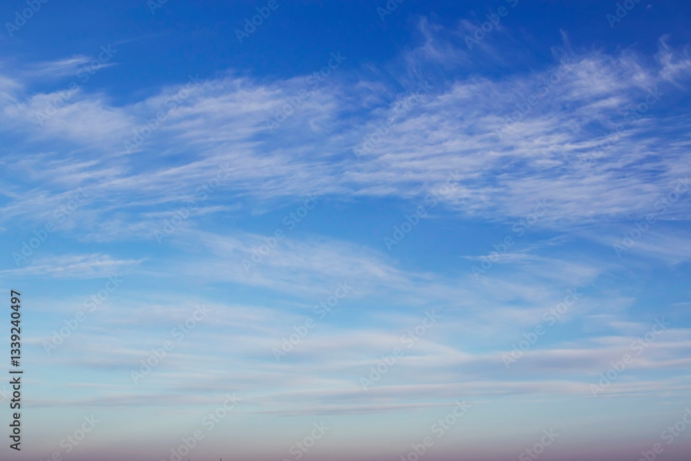 Fototapeta premium Blue sky with beautiful white clouds. Sky with cumulus and cirrocumulus clouds. Panoramic image of the sky.
