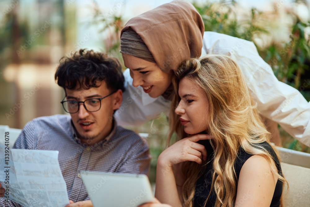 A Diverse MultiEthnic Group Reviewing Projects During a Work Break in a Caffee. A Diverse MultiEthnic Group Reviewing Projects During a Work Break in a Caffee.