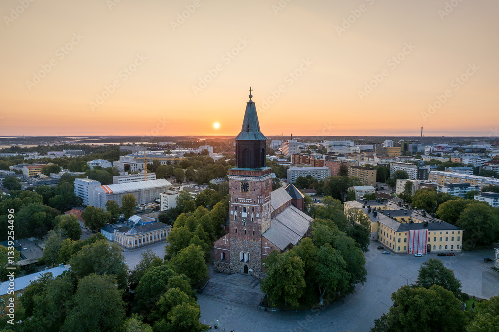 Fototapeta premium Turku Cathedral, Finland’s national shrine, illuminated by the rising sun. Built in the late 13th century and consecrated in 1300, it has been a central part of Finnish history and culture.