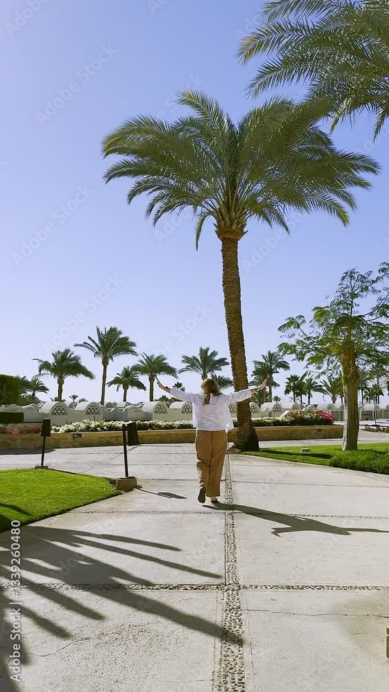Beautiful woman walking in luxury hotel of Egypt, back view, Travel and vacation concept Beautiful woman walking in luxury hotel of Egypt, back view, Travel and vacation concept