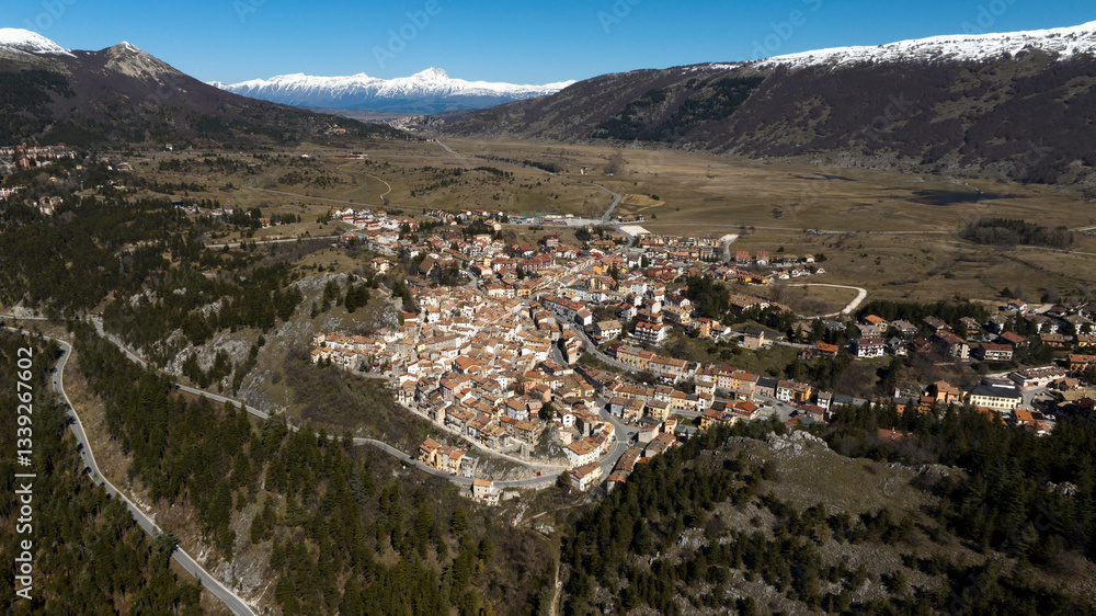 Naklejka premium Aerial view of Ovindoli, a small town located in the province of L'Aquila, in Abruzzo, Italy. It is a popular winter resort in the Apennines. In the background is the Gran Sasso mountain range.