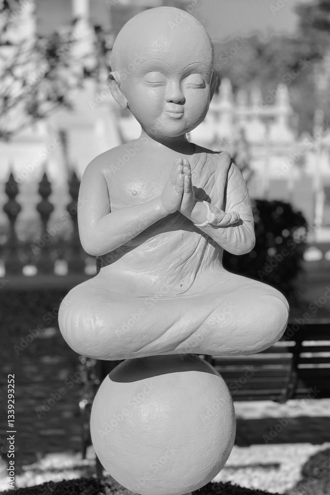 Statues of little monk meditating in the White Temple in Thailand