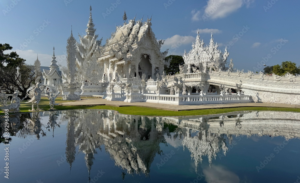 Reflection of the White Temple on the pool in Chiang Rai, Thailand