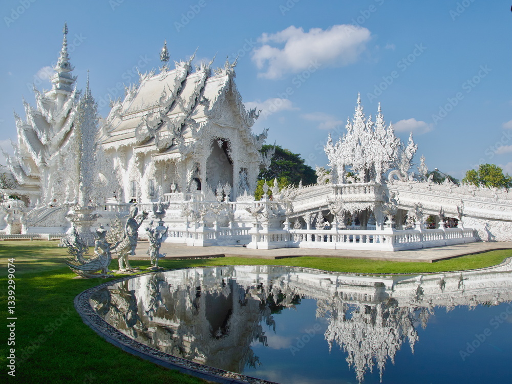 Reflection of the White Temple on the pool in Chiang Rai, Thailand