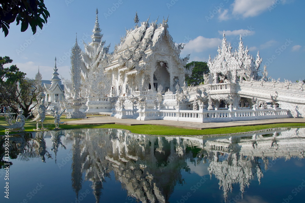 Reflection of the White Temple on the pool in Chiang Rai, Thailand