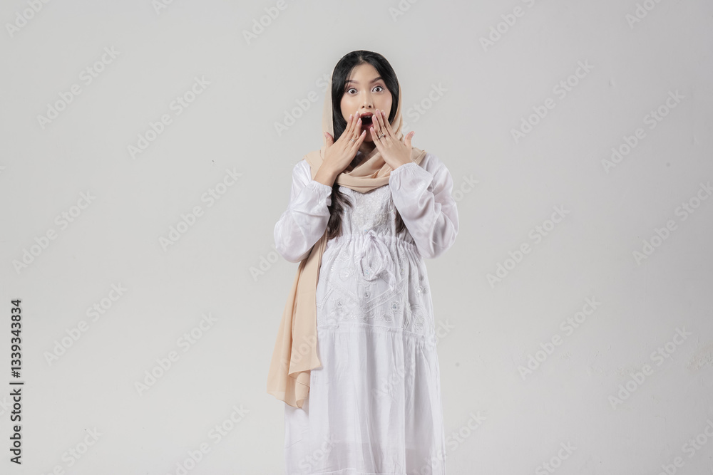 Surprised Asian Muslim pregnant woman wearing hijab with shocked expression. Surprised Asian Muslim pregnant woman wearing hijab with shocked expression.